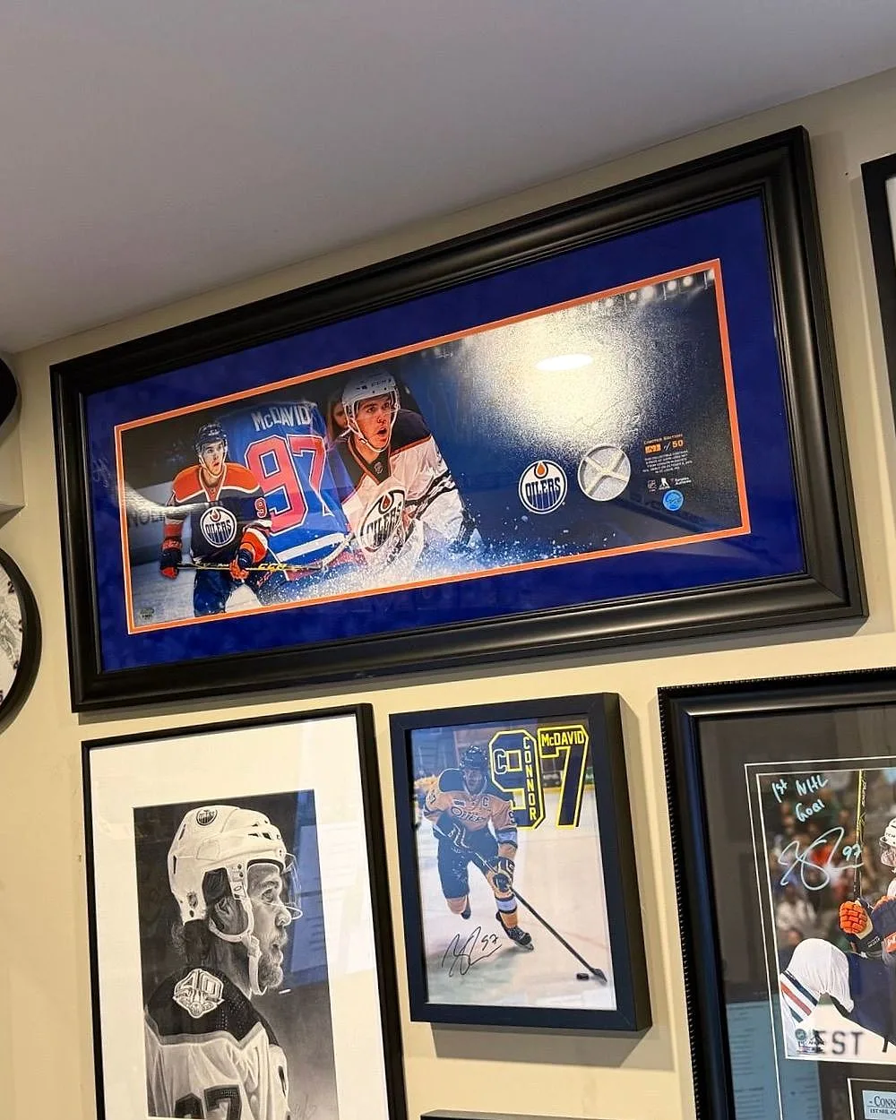 Framed hockey memorabilia and sports cards in the Relic Roster founder's collection room
